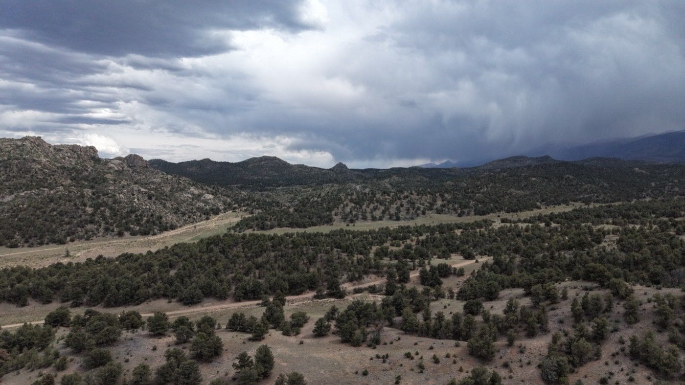Dramatic storm clouds rolling over a mountain ridge